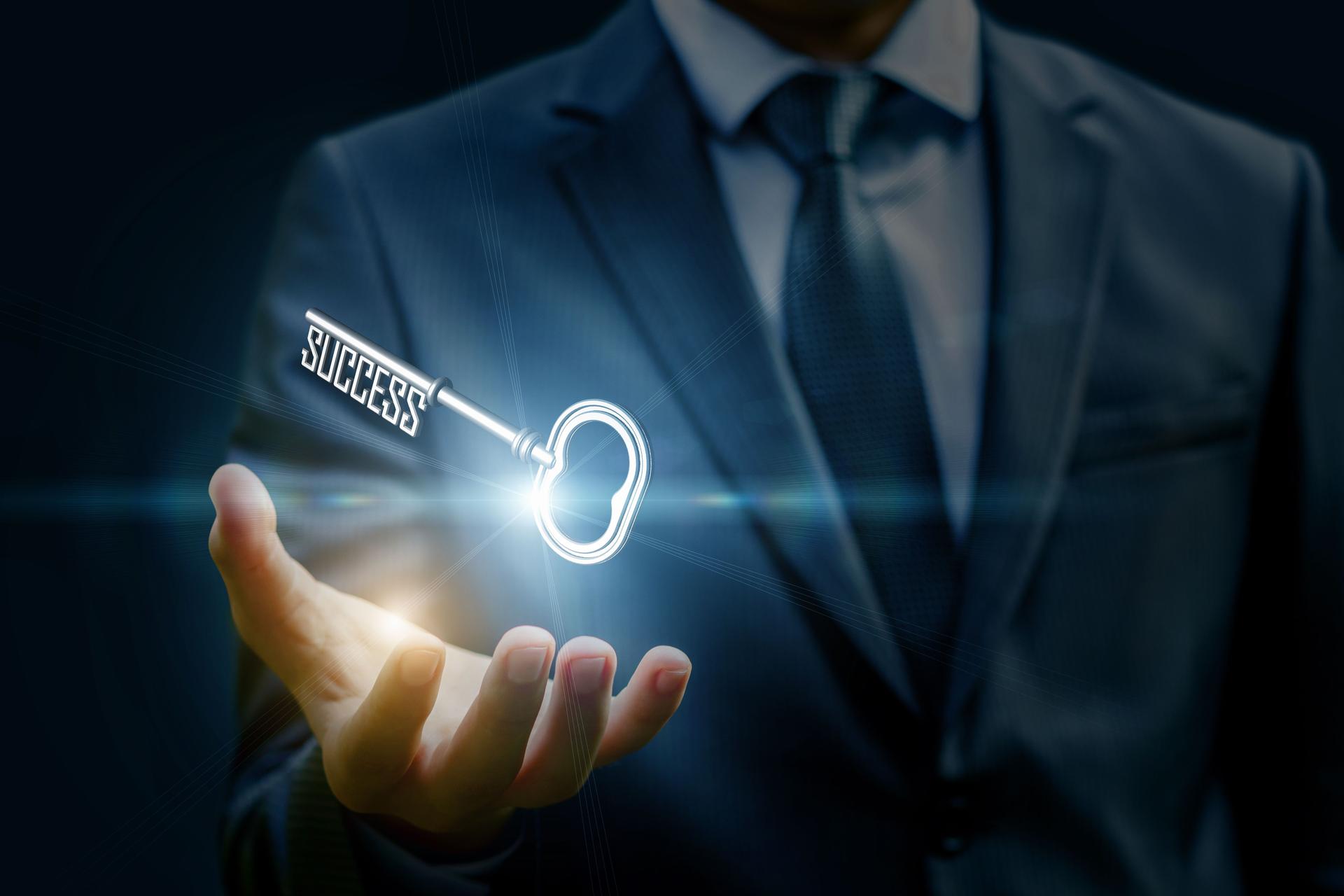 Businesswoman showing a key in his hand.