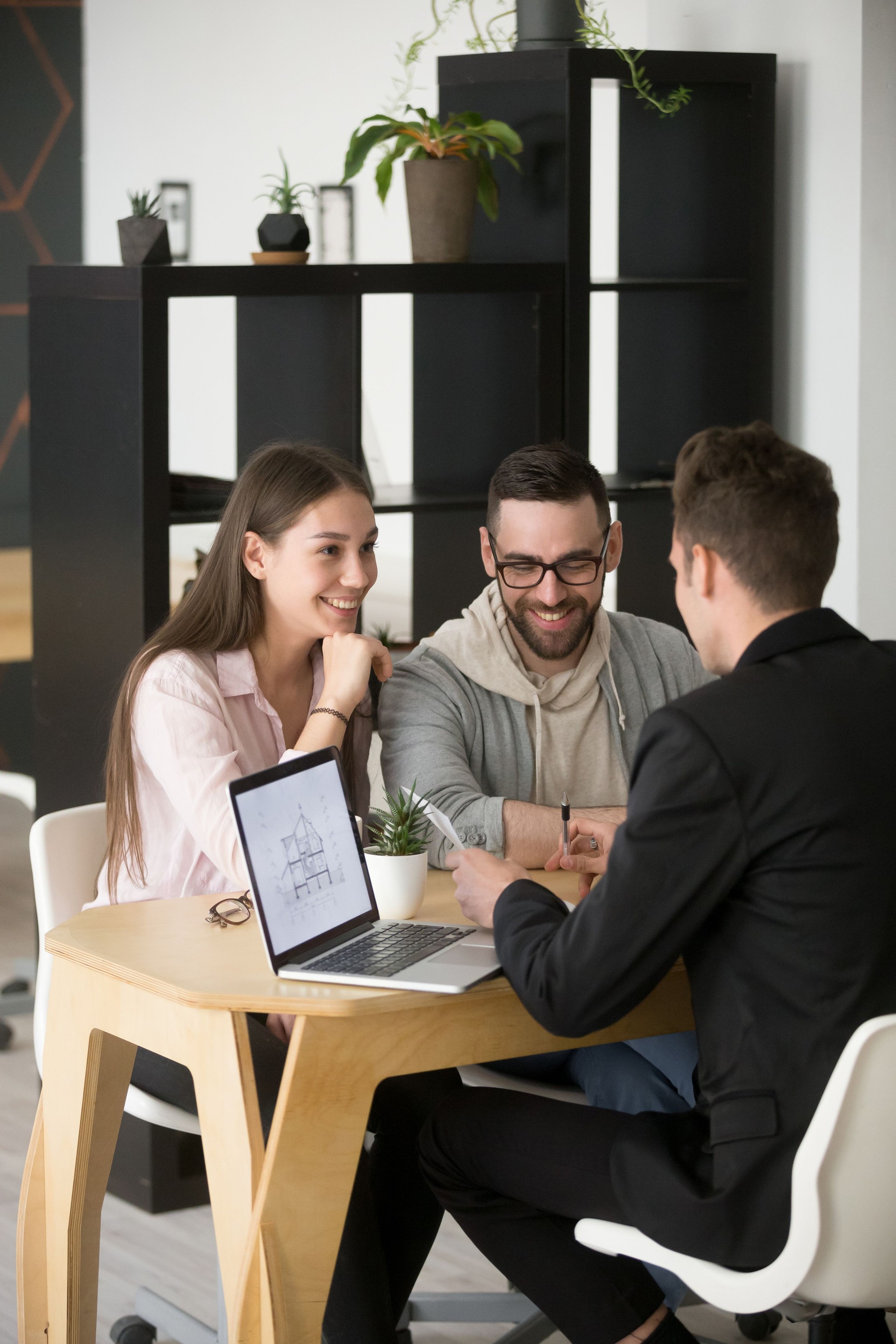 Architect discussing house project with millennial buyers couple